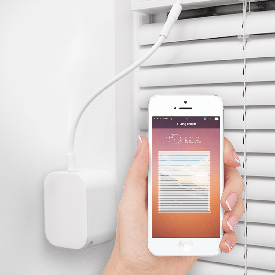 SOMA Tilt 2 installed on a window blind with mobile phone showing the Smart Shades app